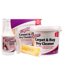 A product image featuring the Capture Carpet 4 Pound Cleaning Kit which includes a bottle labeled 'pre-mist', a white container marked 'dry cleaner', and a brush with a yellow handle. The packaging is primarily purple and white with text and branding.